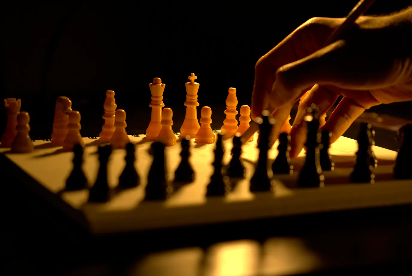 Man drafting strategy while a chess game is at play.