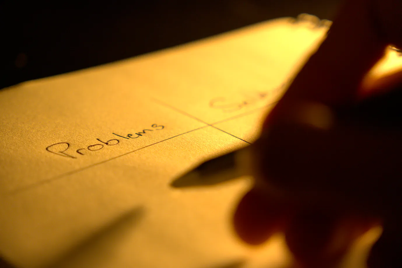Man drafting a list of problems and solution in his notebook.