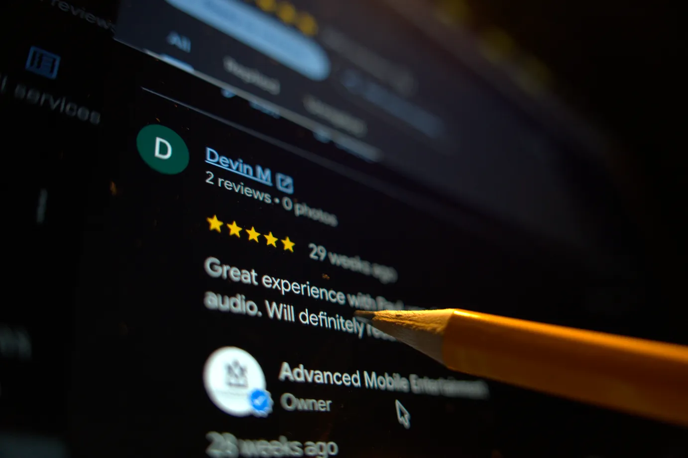 Man reading a five star google review for a business.