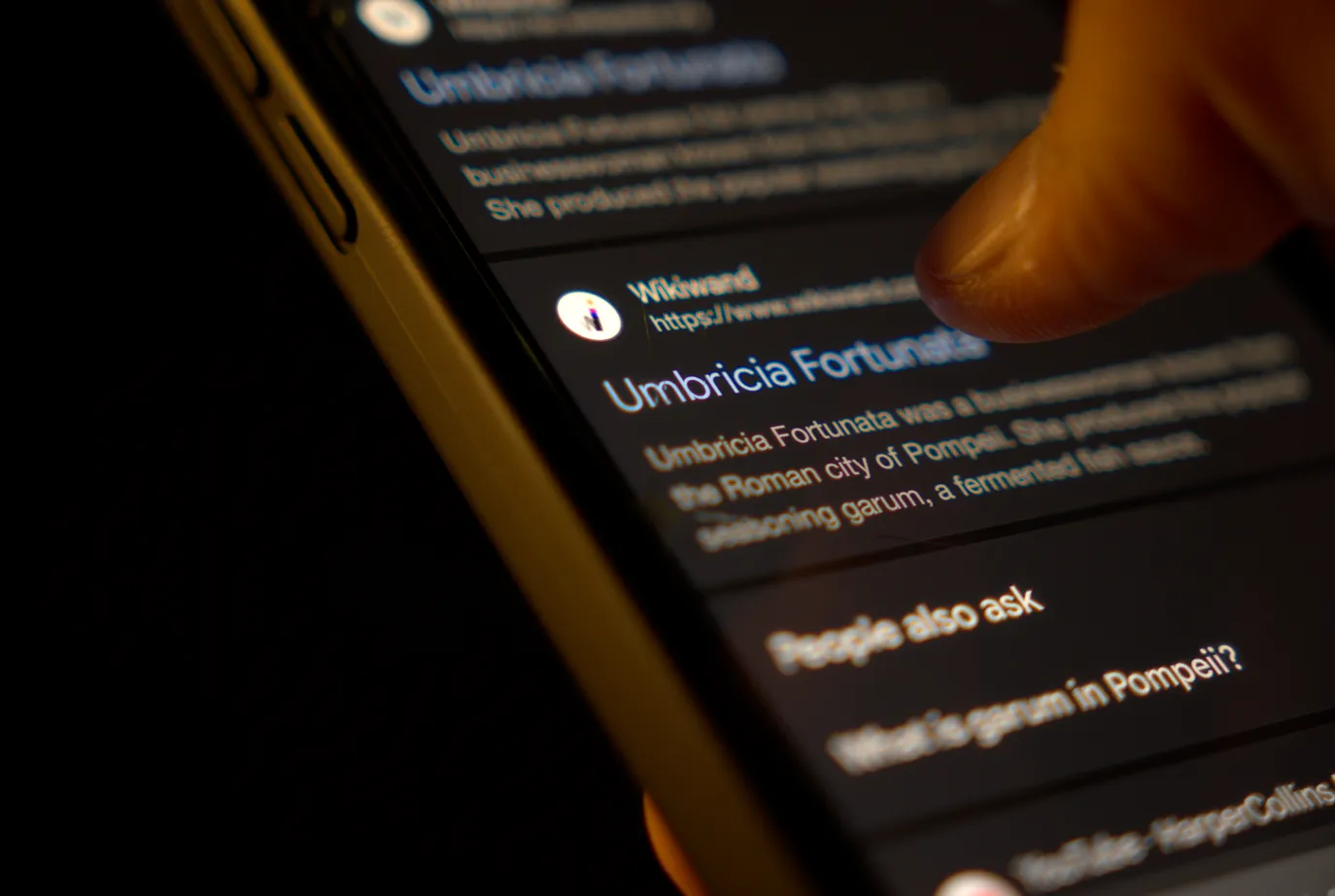 Man reviewing online articles on a phone.
