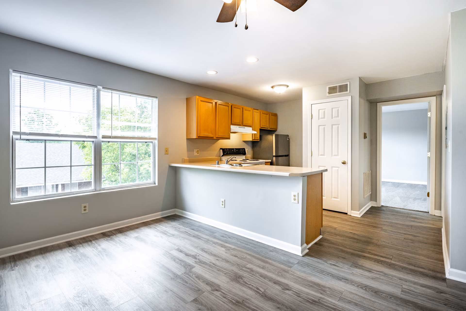 Kitchen with breakfast bar brown cabinets and stainless steel and white appliances