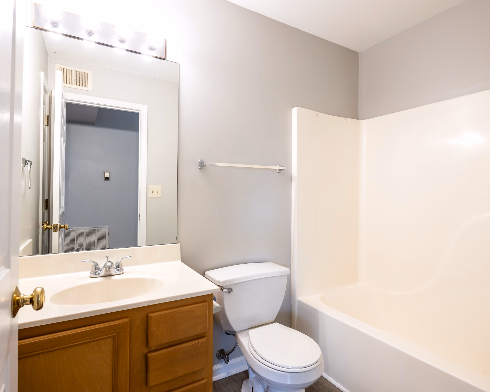 Bathroom with brown cabinets and shower tub combo