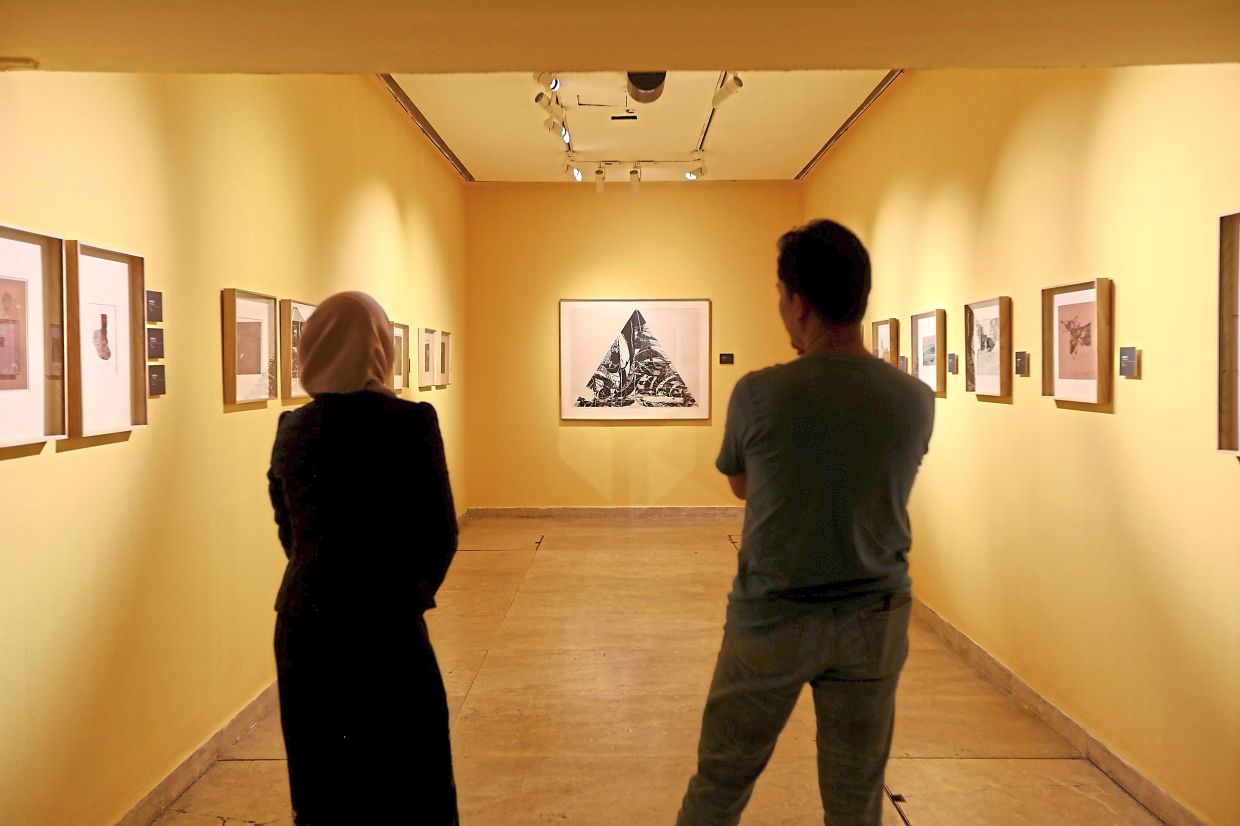 Visitors can step into veteran printmaker Juhari’s early years through a series of classic works displayed alongside a Japanese City Pop playlist that soundtracks his time studying in Tokyo. Photo: The Star/Low Lay Phon