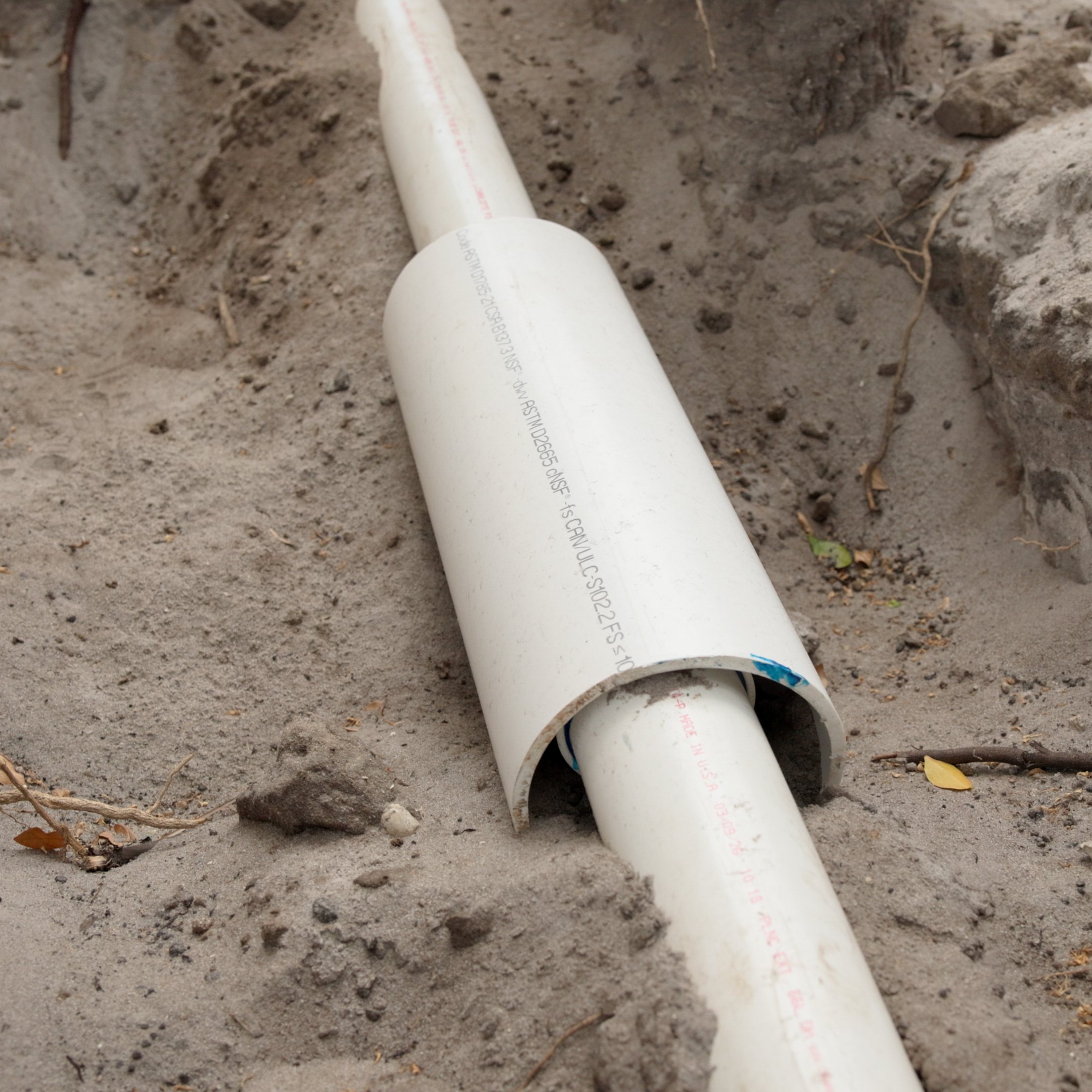 PVC line with a coupling in a trench