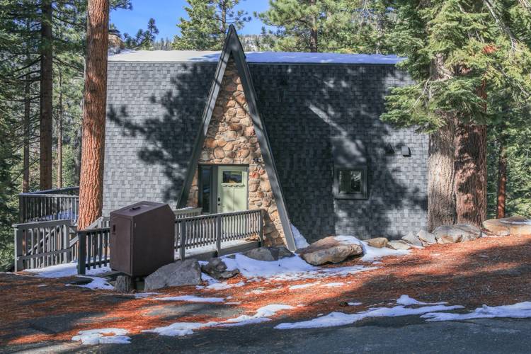 Backcountry Chalet great room with stone fireplace and spiral staircase — Incline Village Lake Tahoe