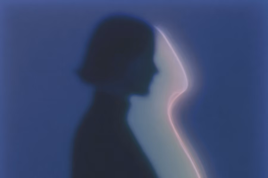 Blurry silhouette of a person facing a glowing, abstract profile outline against a blue background.