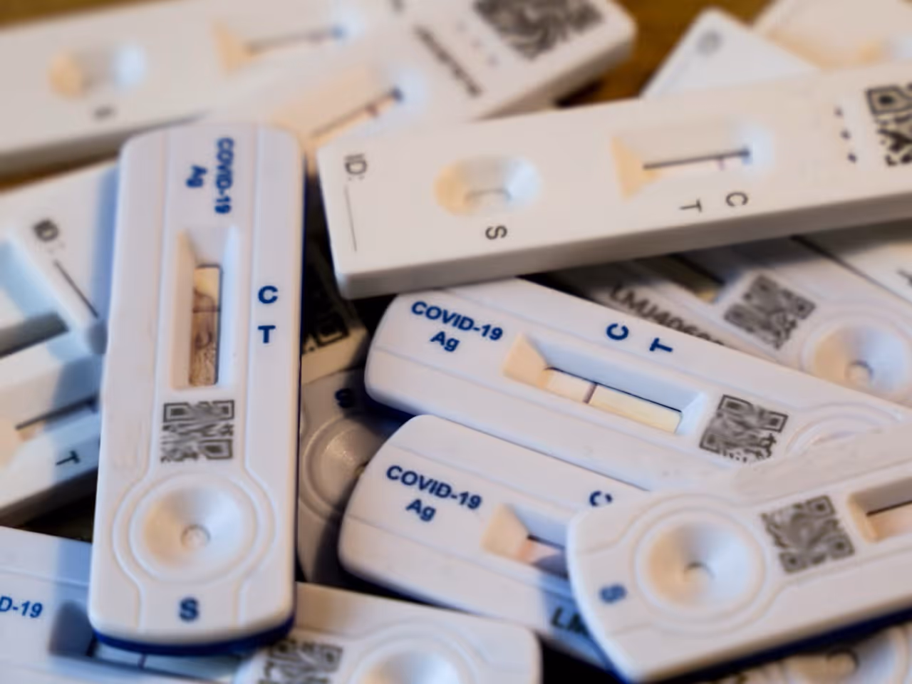 A collection of COVID-19 rapid antigen test kits, representing infectious disease testing and public health