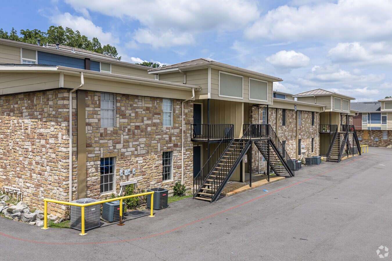 Exterior stone building with staircase and private balconies