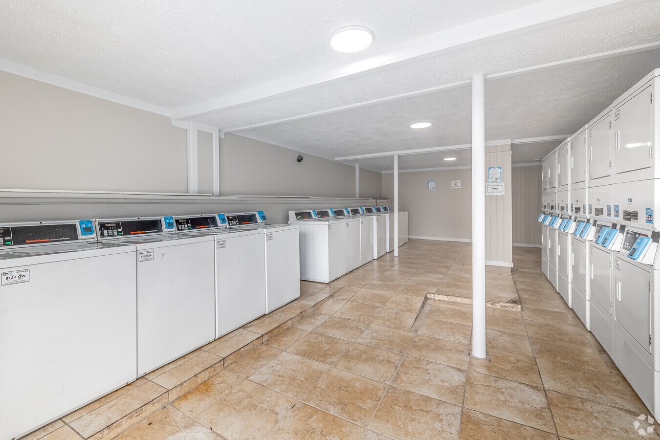 On-site community laundry room with commercial washers and dryers