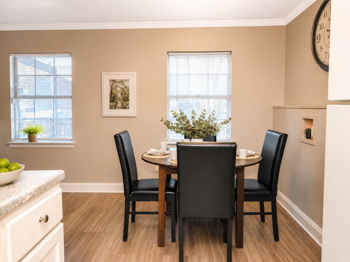 Staged dining area with round table and natural light