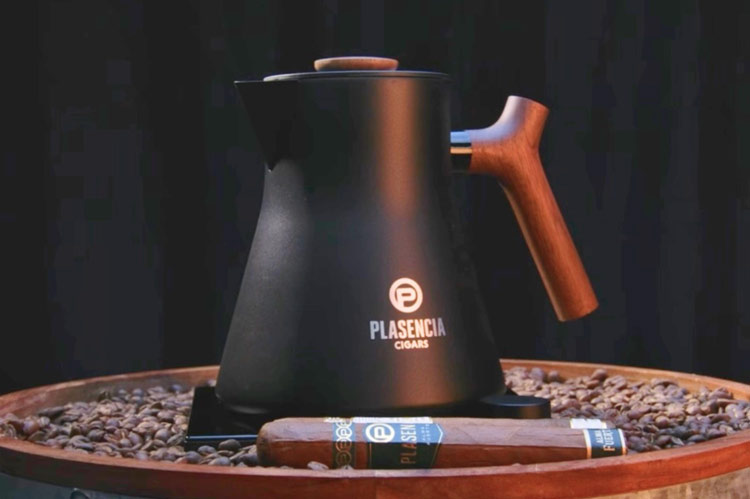 Plasencia Cigars branded black carafe with a cigar displayed on coffee beans