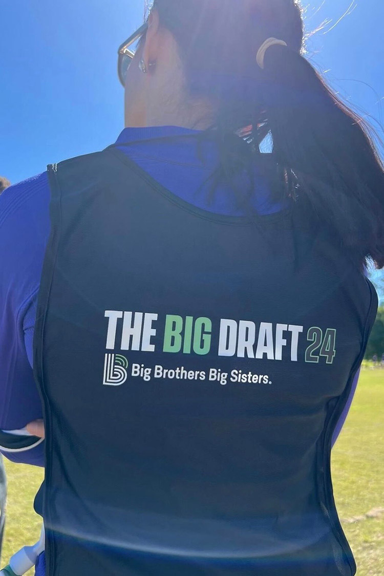 Person wearing a Big Brothers Big Sisters Big Draft 24 branded event vest