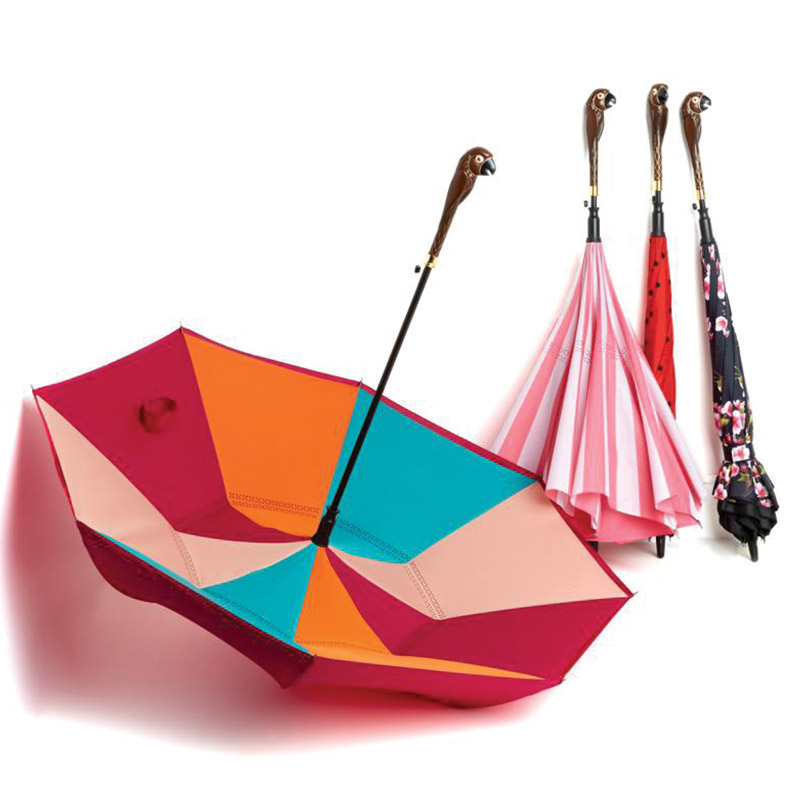 Colorful inverted umbrella with several folded patterned umbrellas