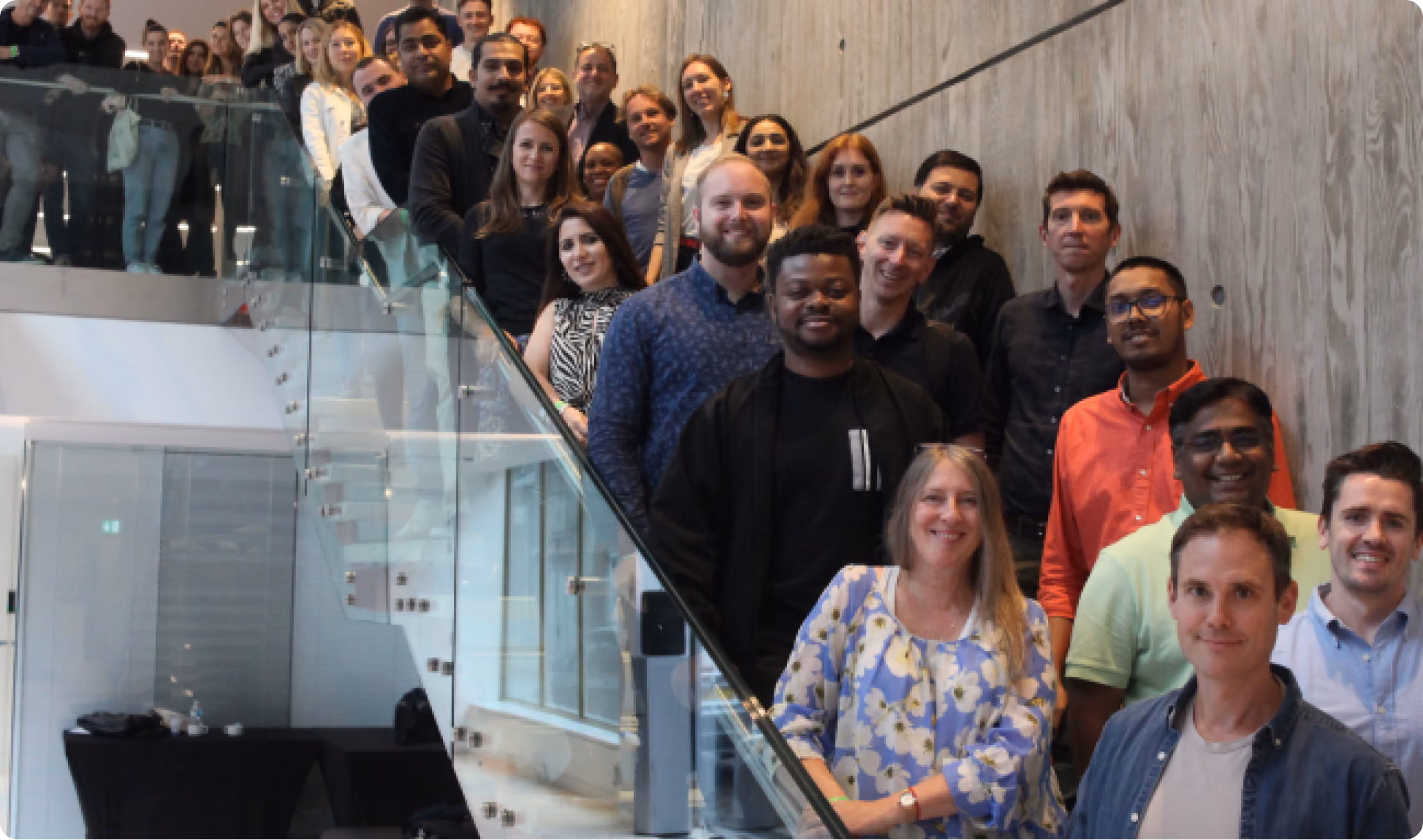 Flixmedia team gathered on an office staircase