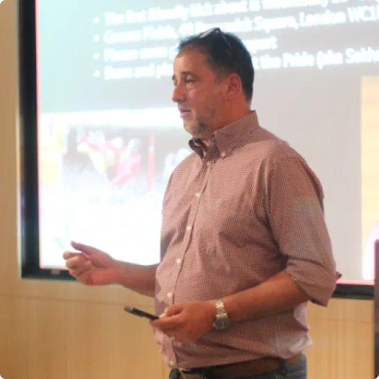 Flixmedia colleague presenting to an audience in front of a screen