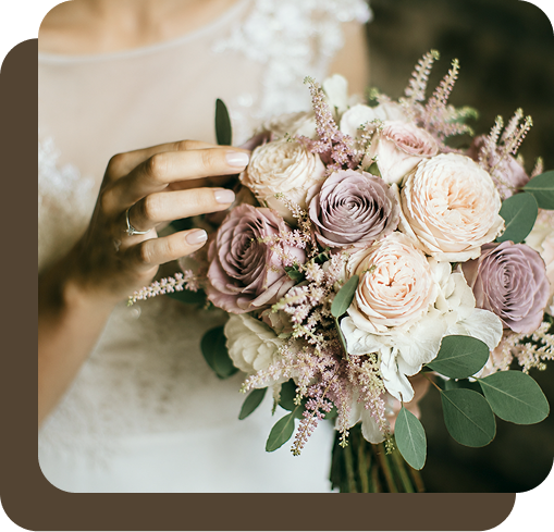 Soft blush roses, white blooms and greenery in a bridal bouquet
