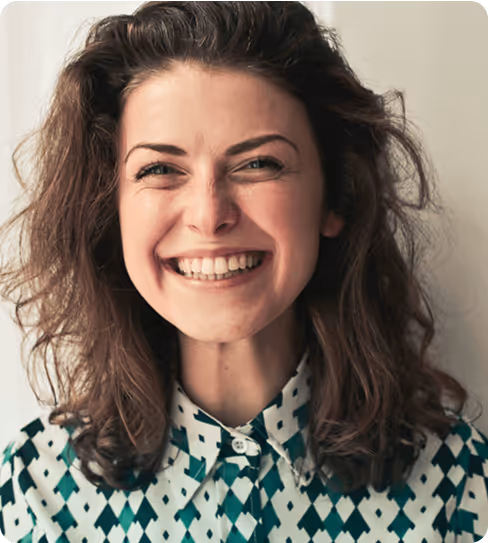 Smiling woman in patterned shirt representing confident and happy professional