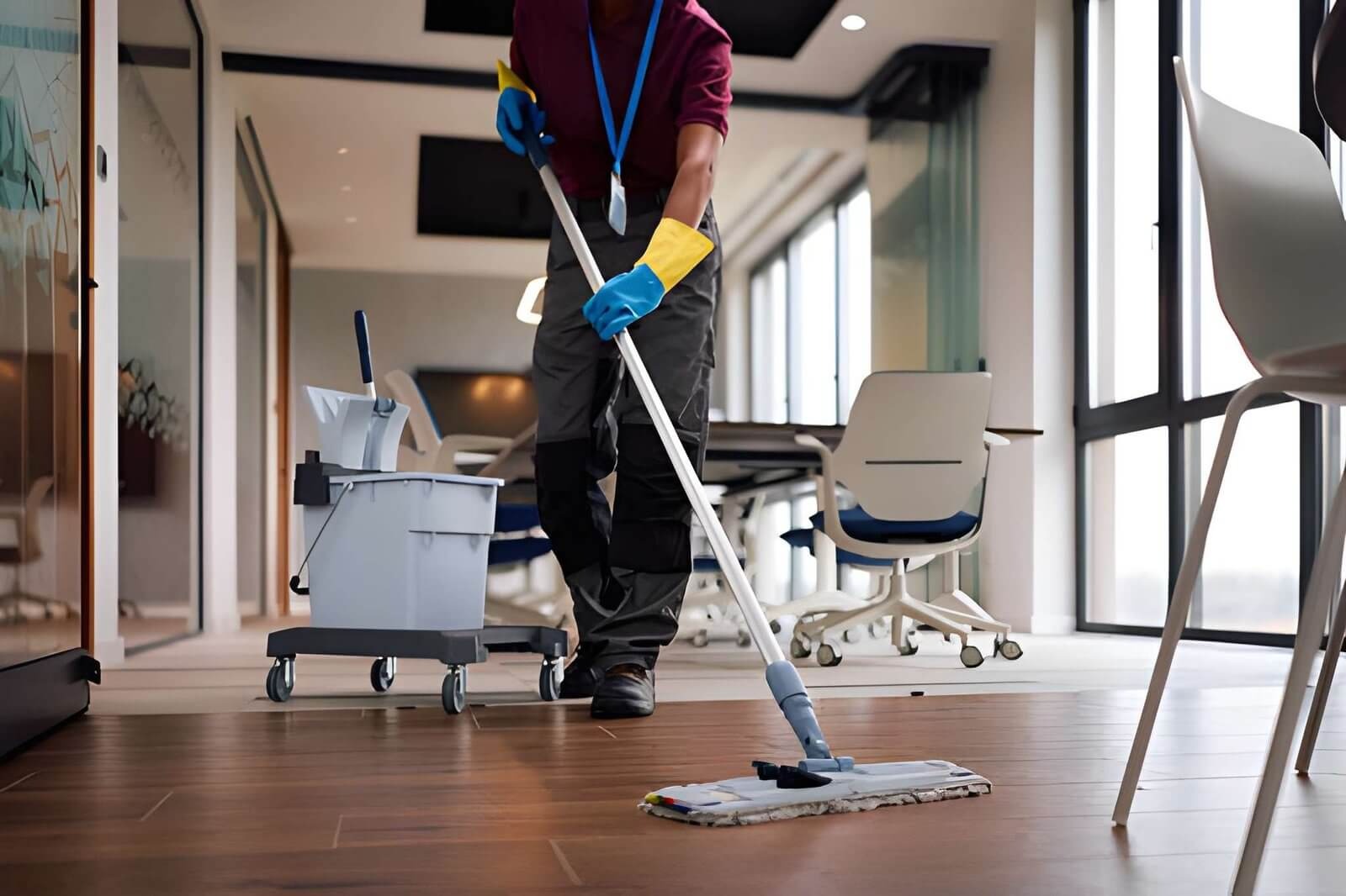 Professional cleaner mopping a modern office floor during commercial cleaning service