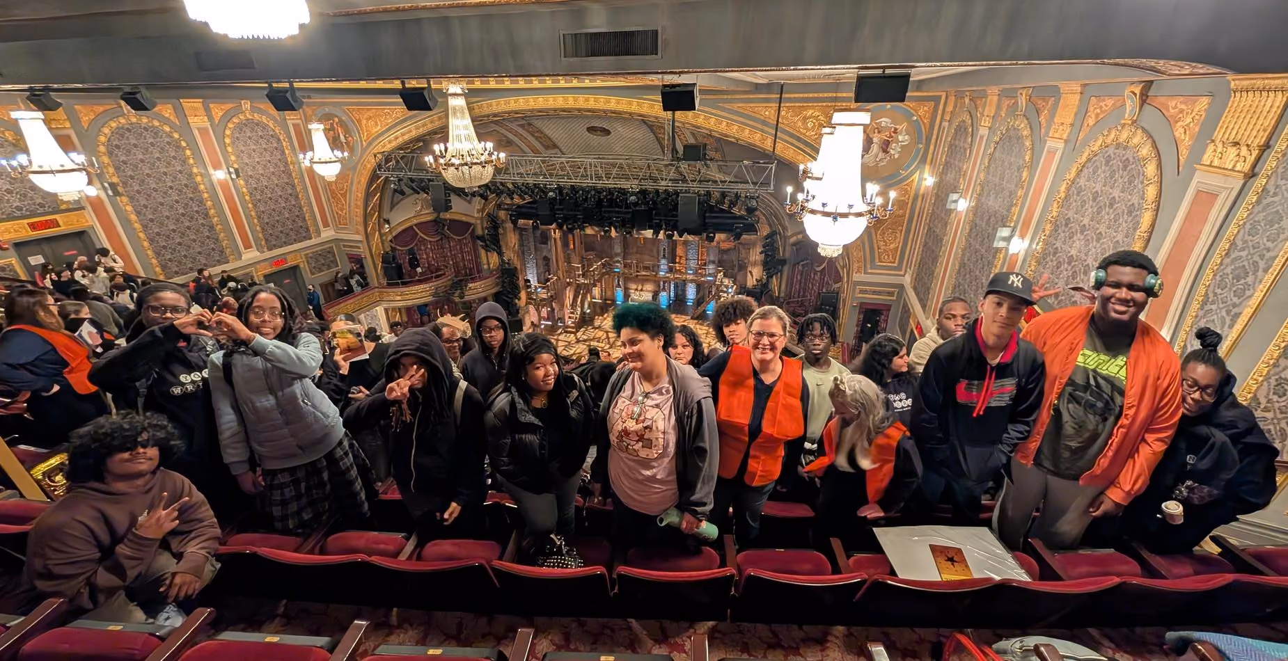Students posing together inside an ornate historic theater on field trip