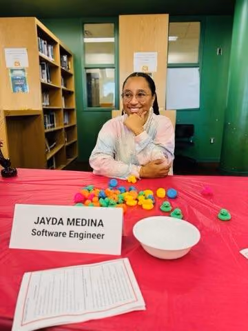 Jayda Medina software engineer smiling at career fair table