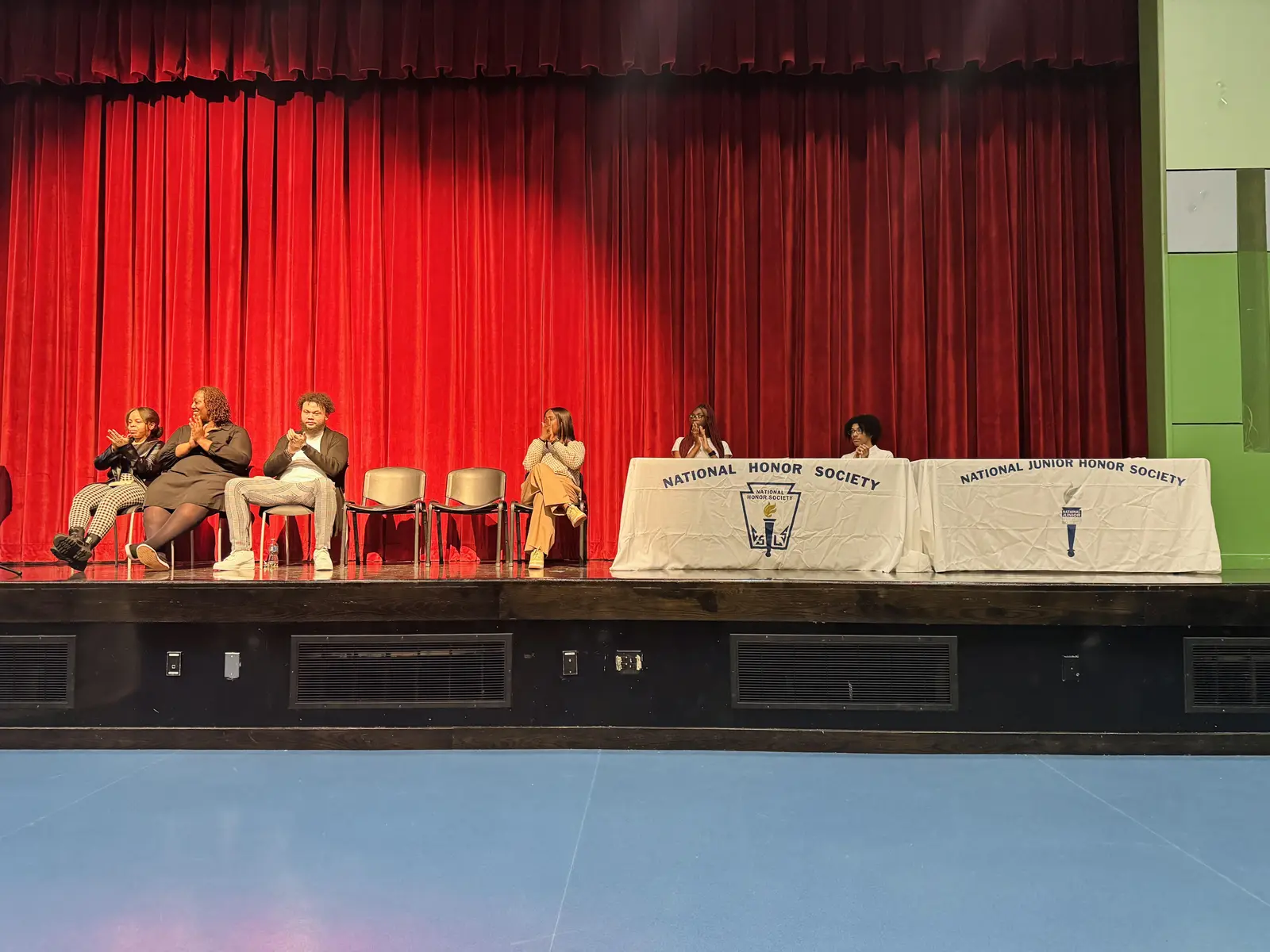 Students seated on stage at National Honor Society induction ceremony