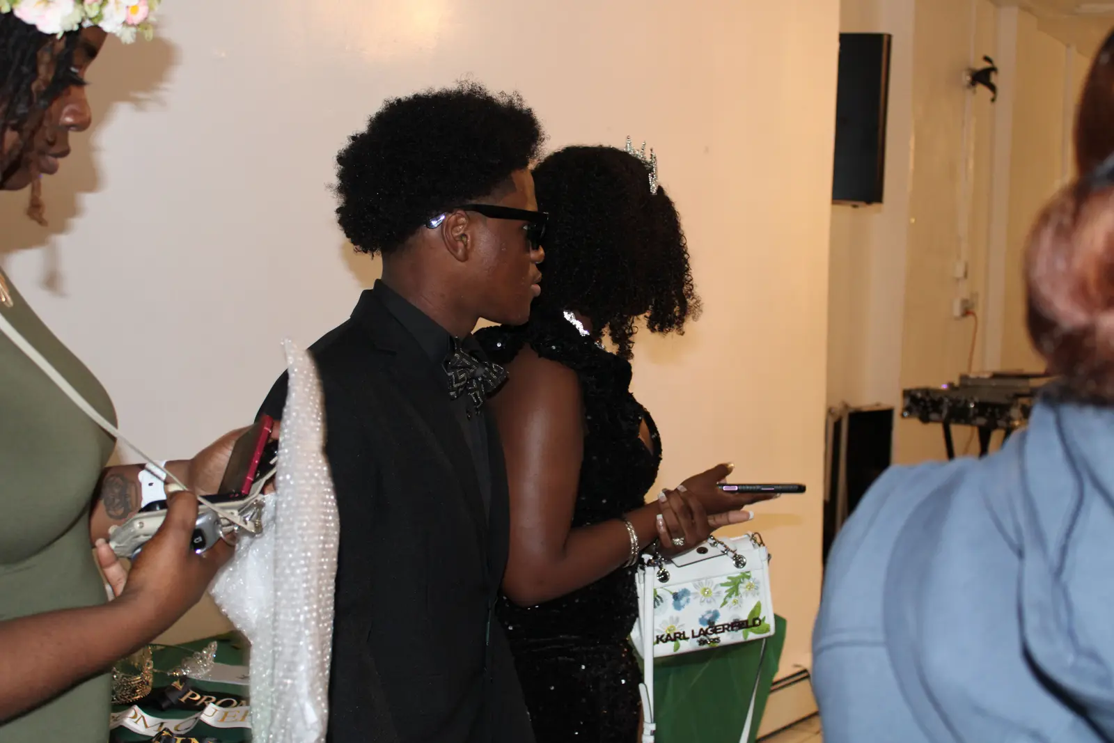 Students dressed formally at a school prom or banquet event