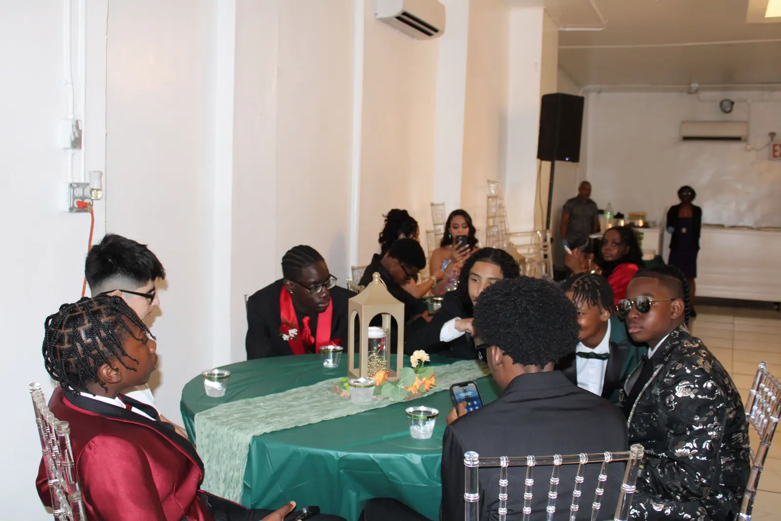 Students dressed formally seated together at a school prom event