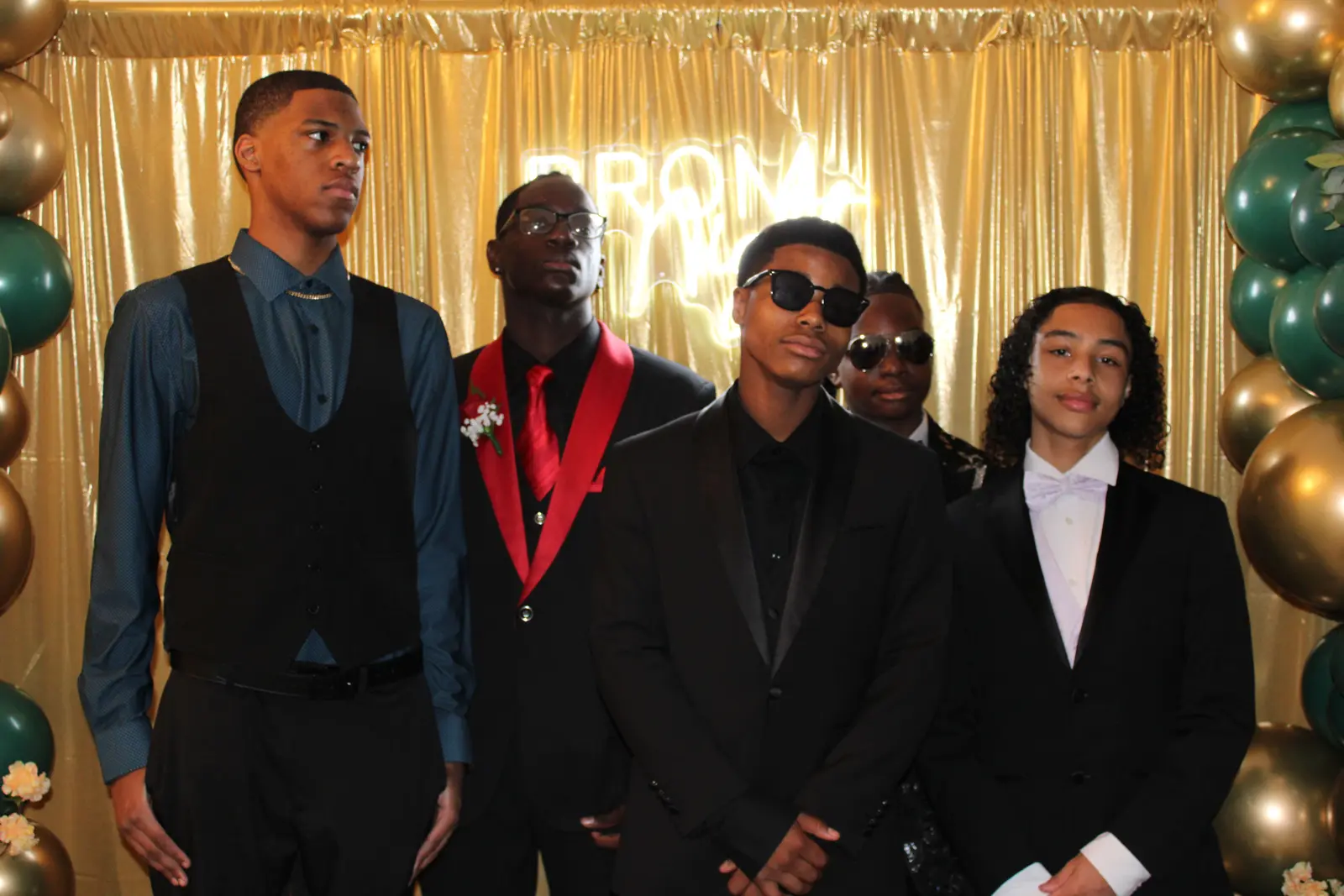 Four male students dressed formally posing at prom