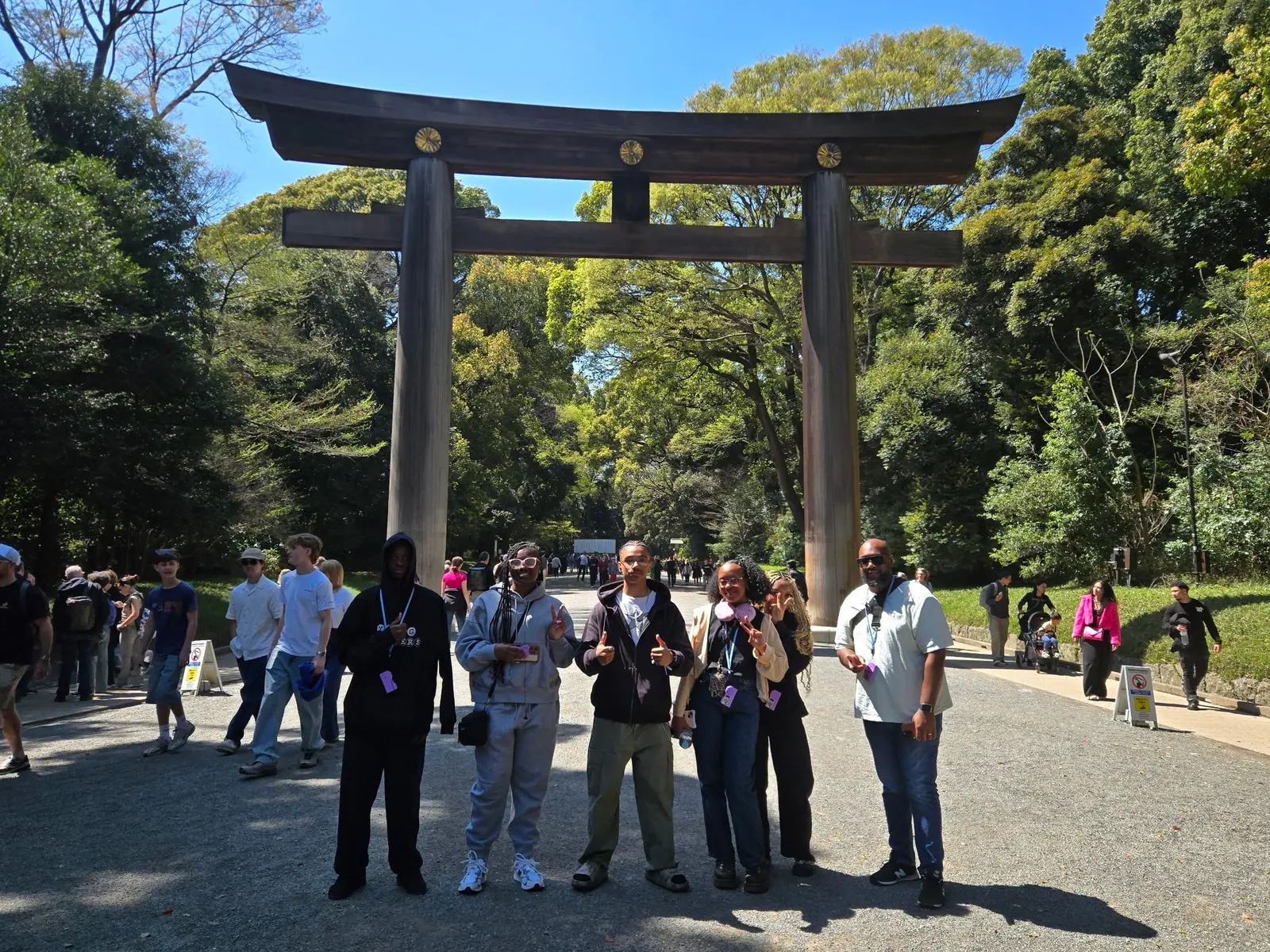 Students posing in front of a large torii gate in Japan