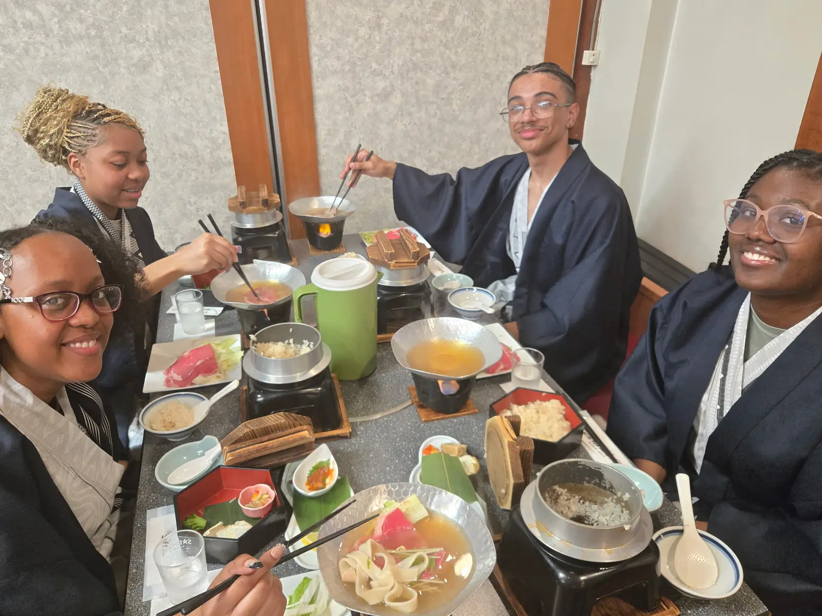 Students in yukatas enjoying a traditional Japanese meal together