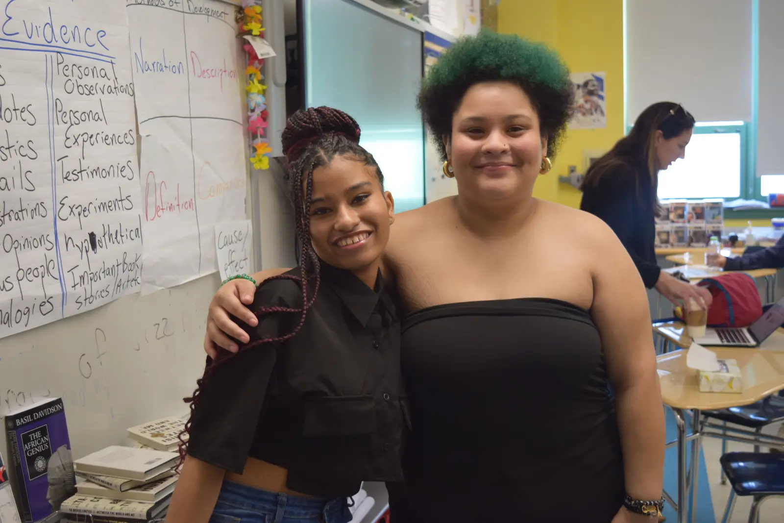Two students smiling together in an English classroom
