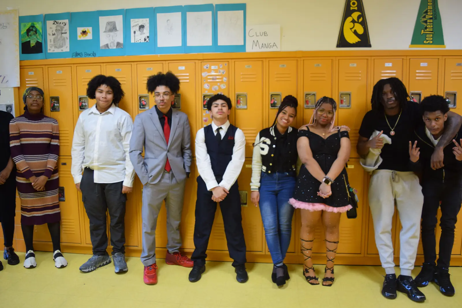 Eight students dressed up posing together by school lockers