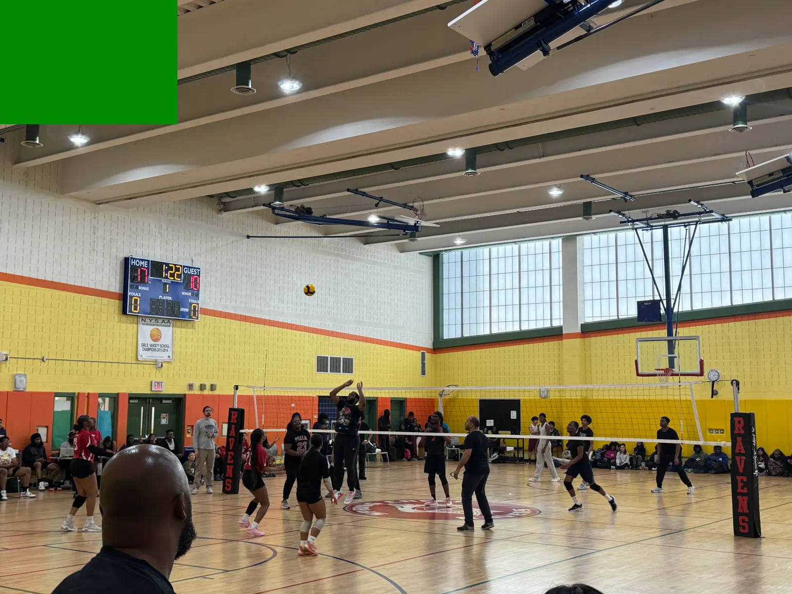 Ravens girls volleyball team competing in a gym match