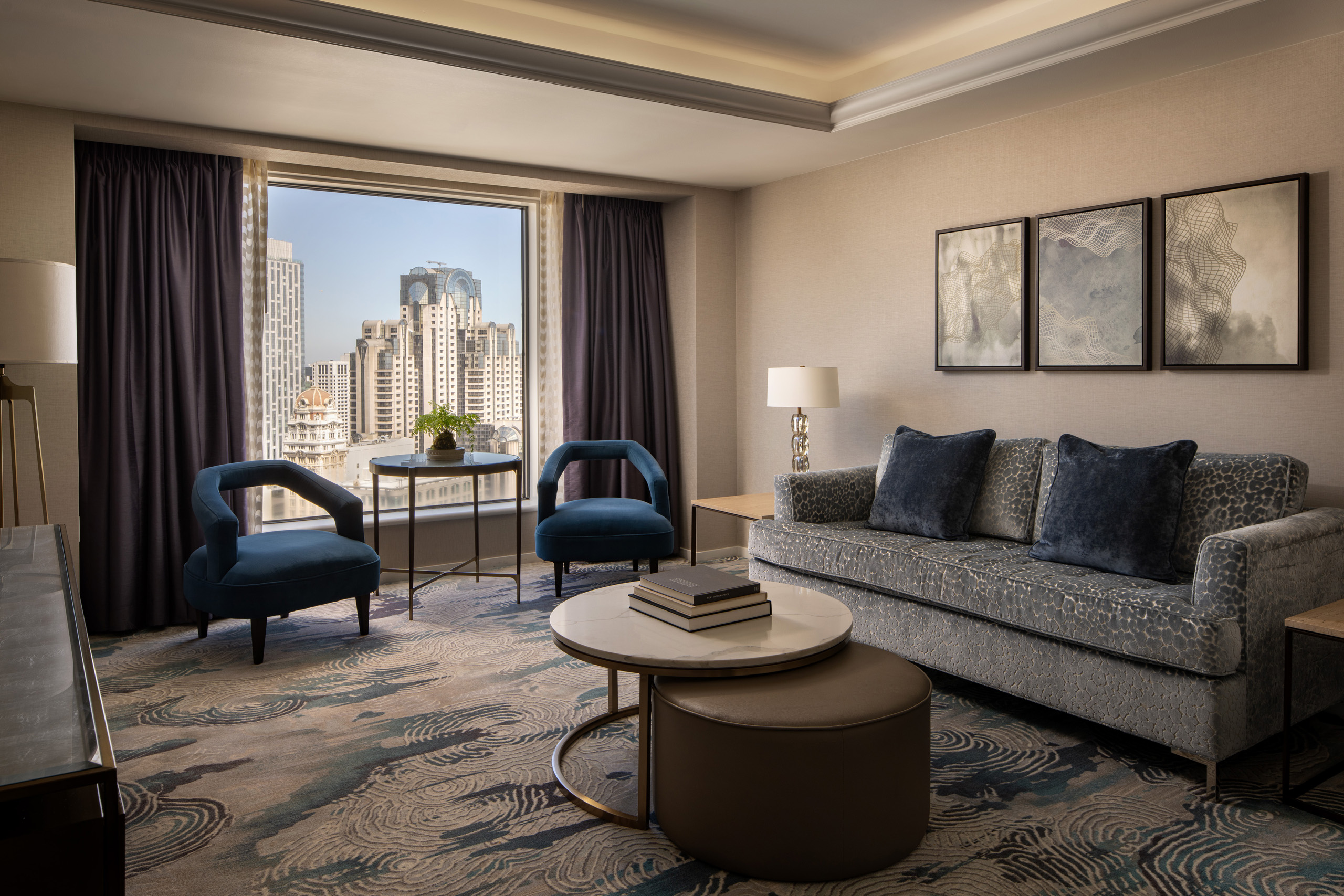 Japanese suite living room with sofa, chairs, and city skyline.