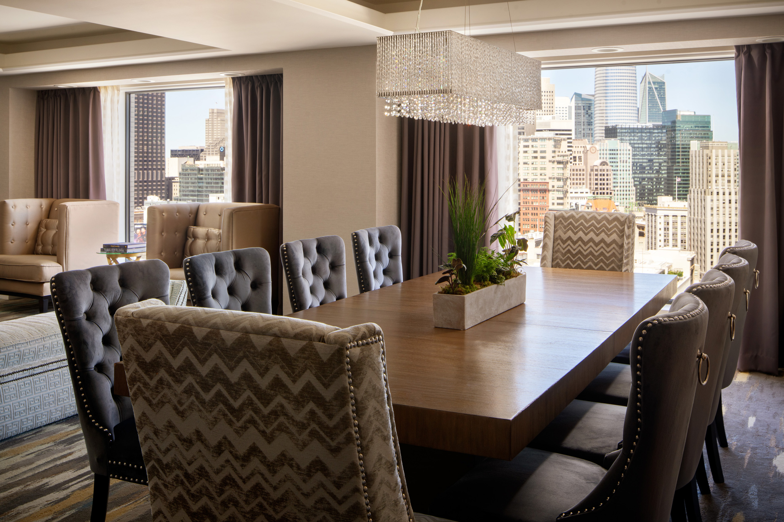 Imperial suite dining room with long table and city views.