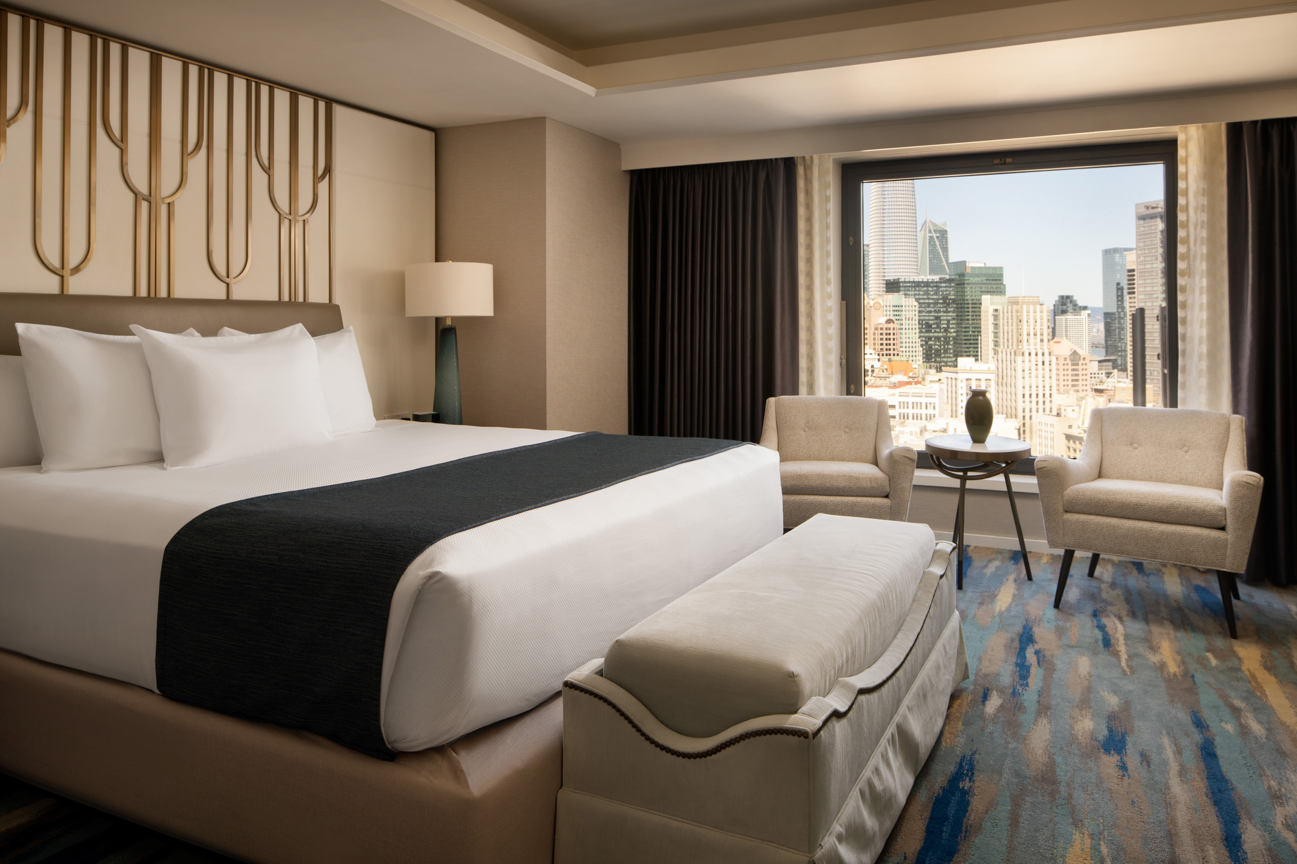 Imperial suite bedroom with king bed and skyline view.