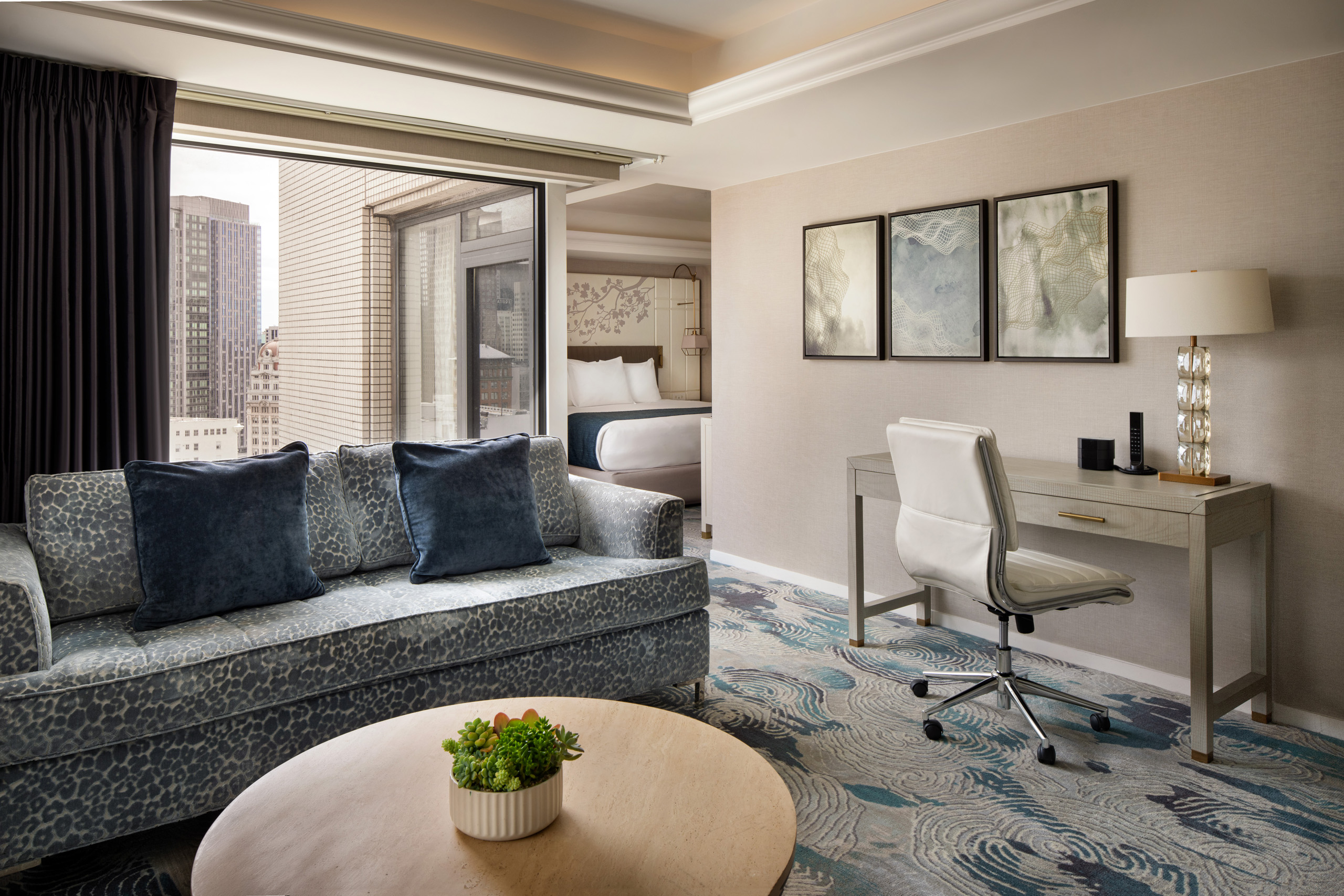 Junior suite living room with sofa, desk, and bedroom entrance.