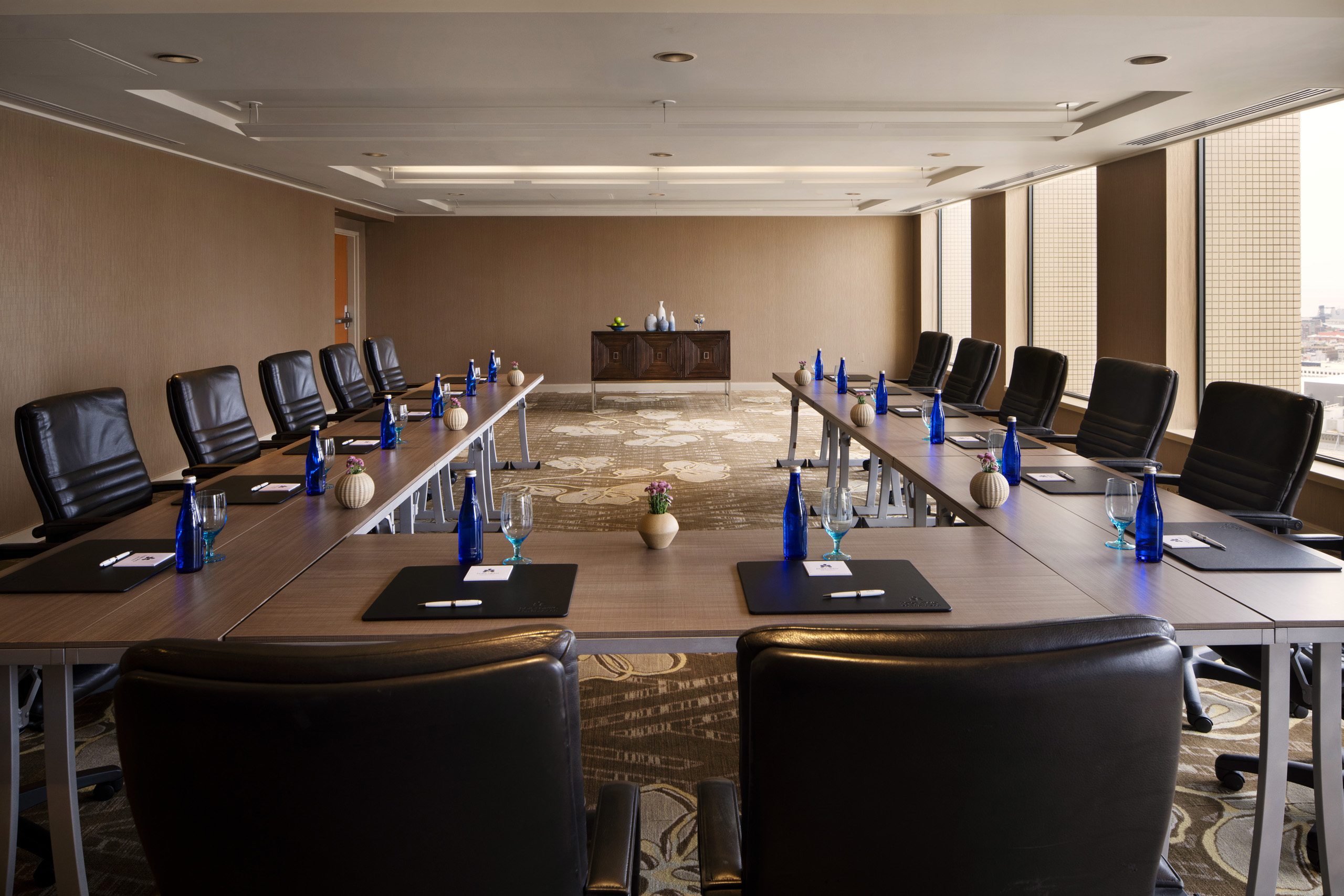 U-shaped meeting room with conference seating.