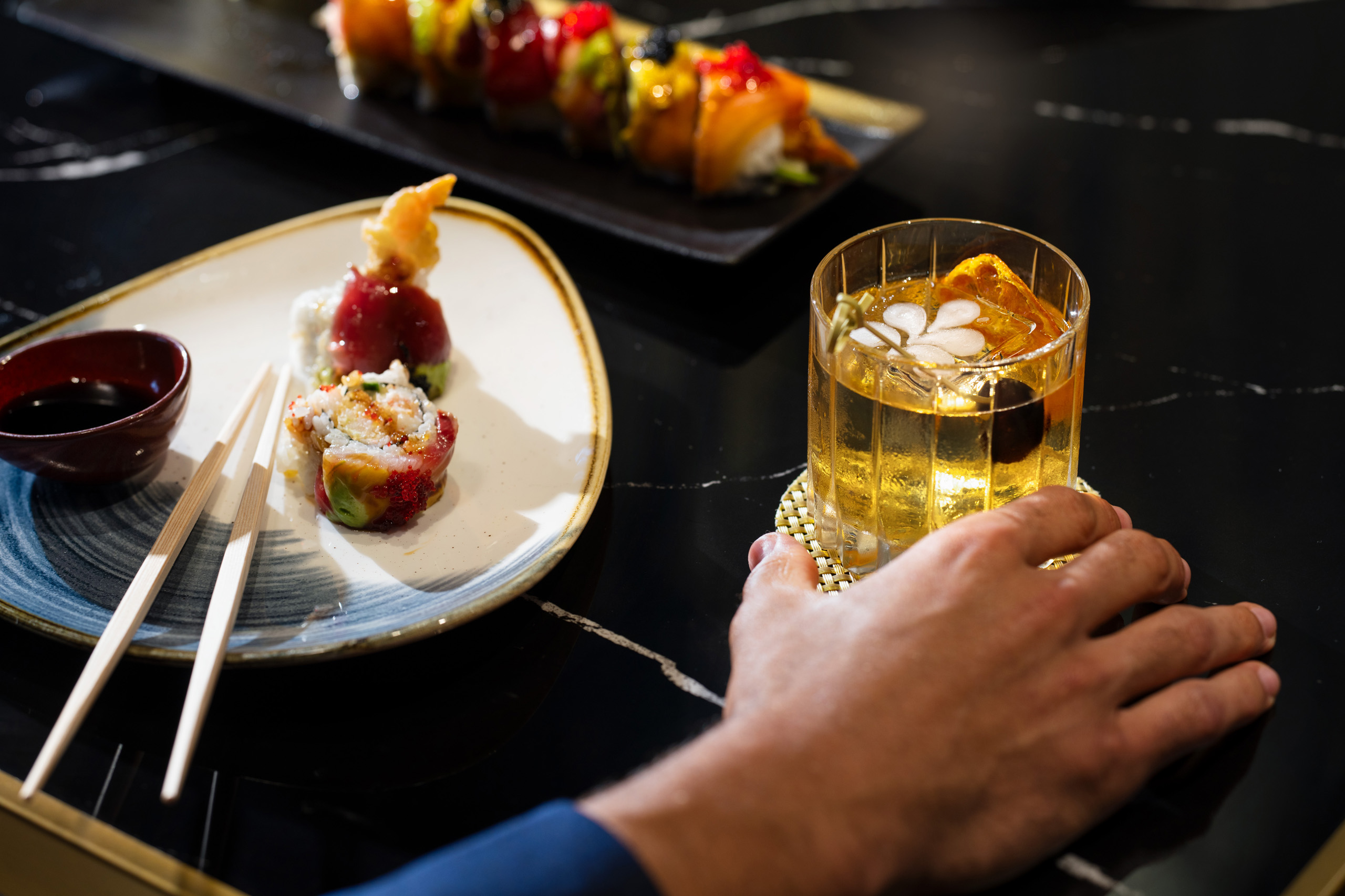 Cocktail beside sushi and chopsticks