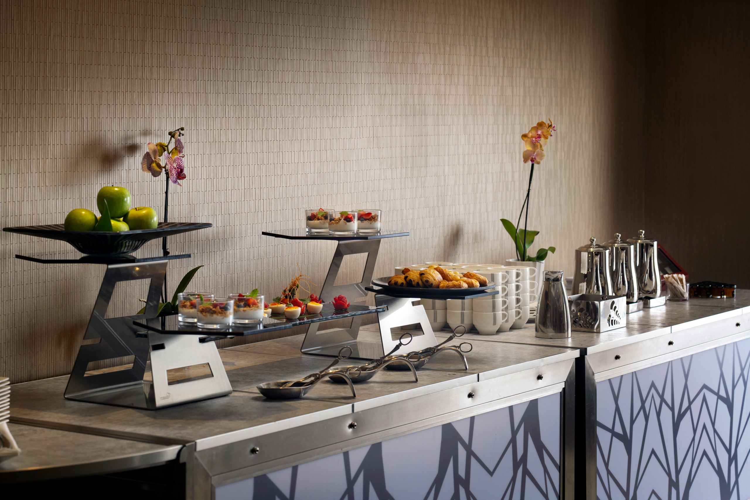 Breakfast buffet with pastries, fruit, and coffee service