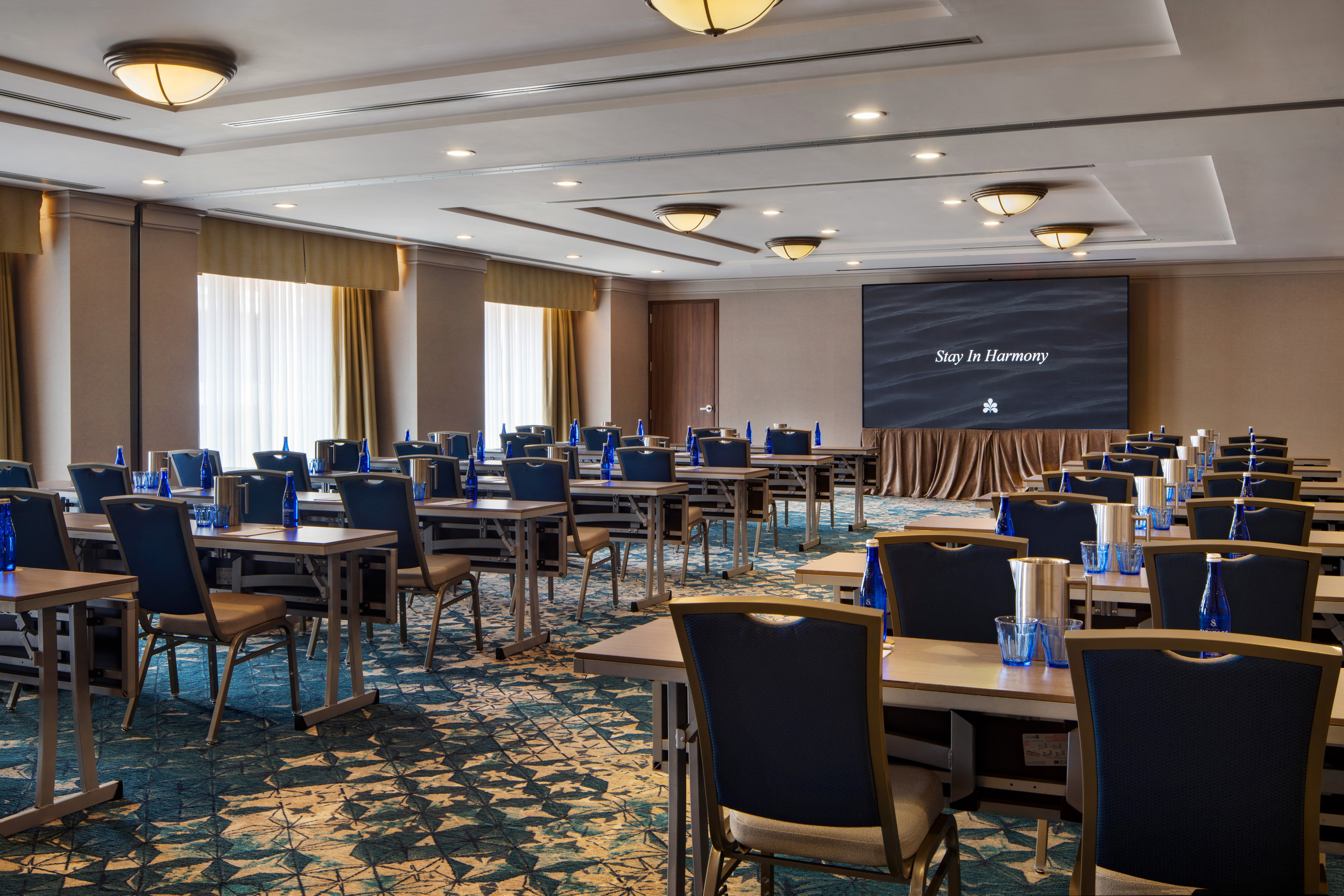 Classroom-style meeting room with projection screen and conference seating.