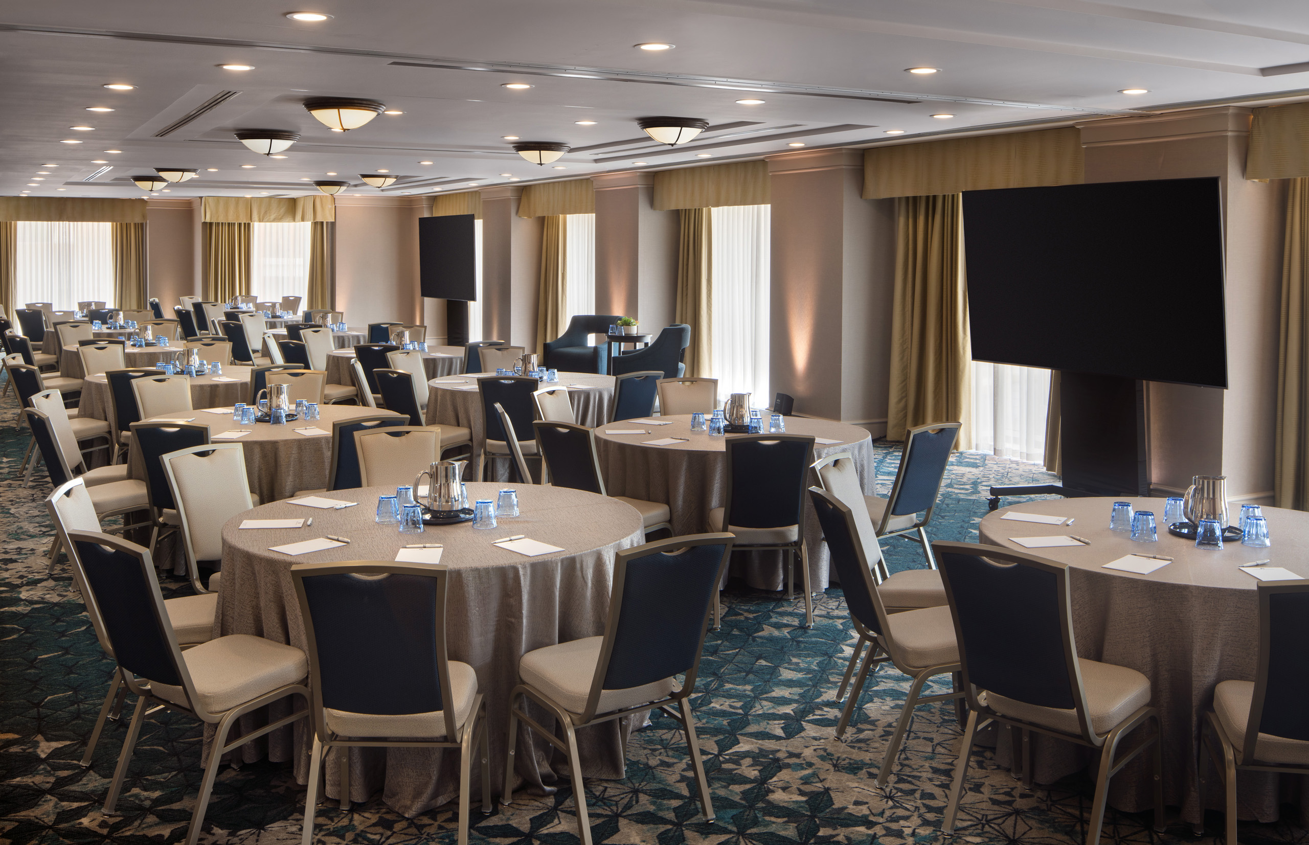 Conference room with round tables and presentation screens