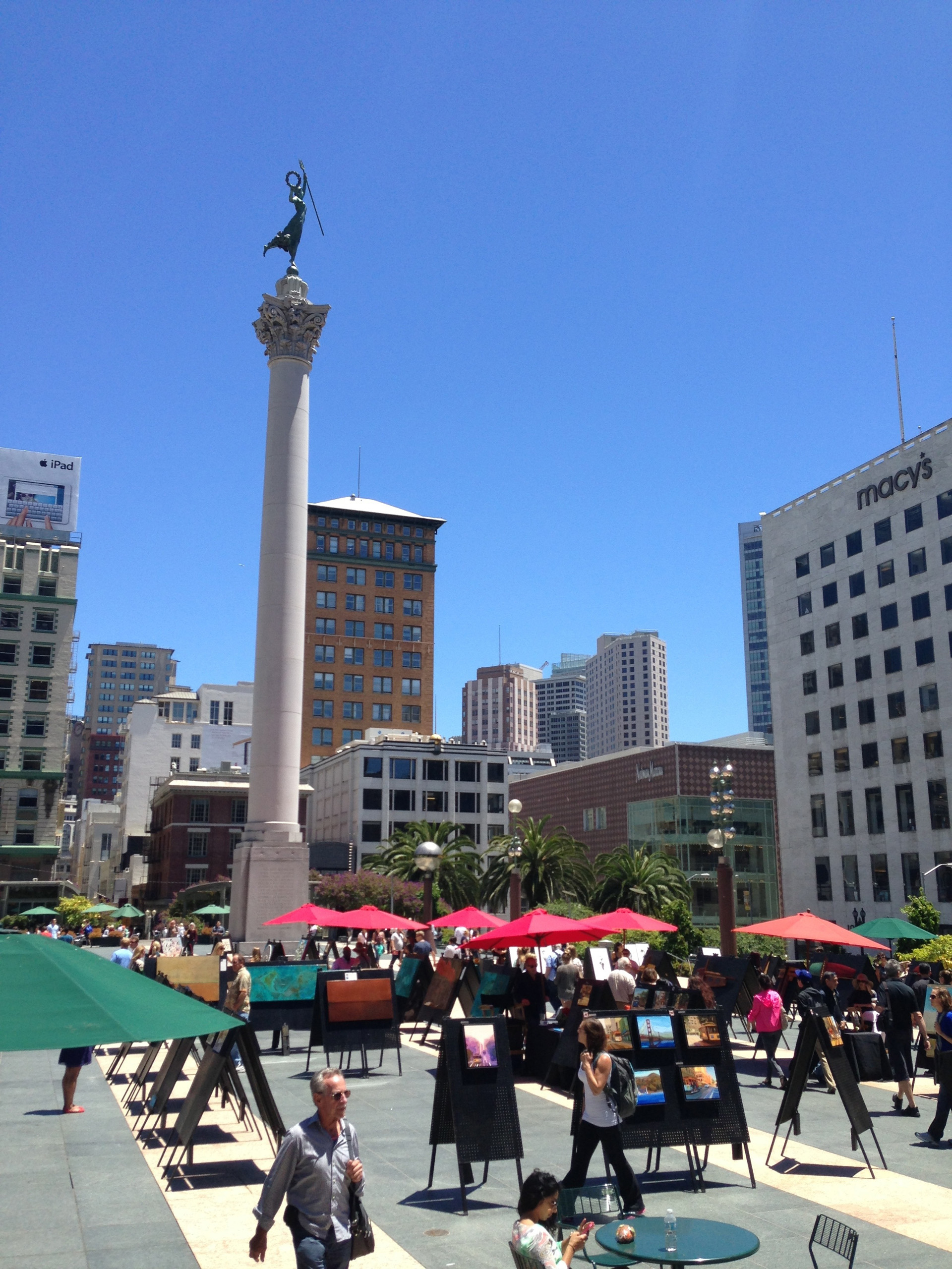Union Square with monument, art displays, and surrounding buildings.