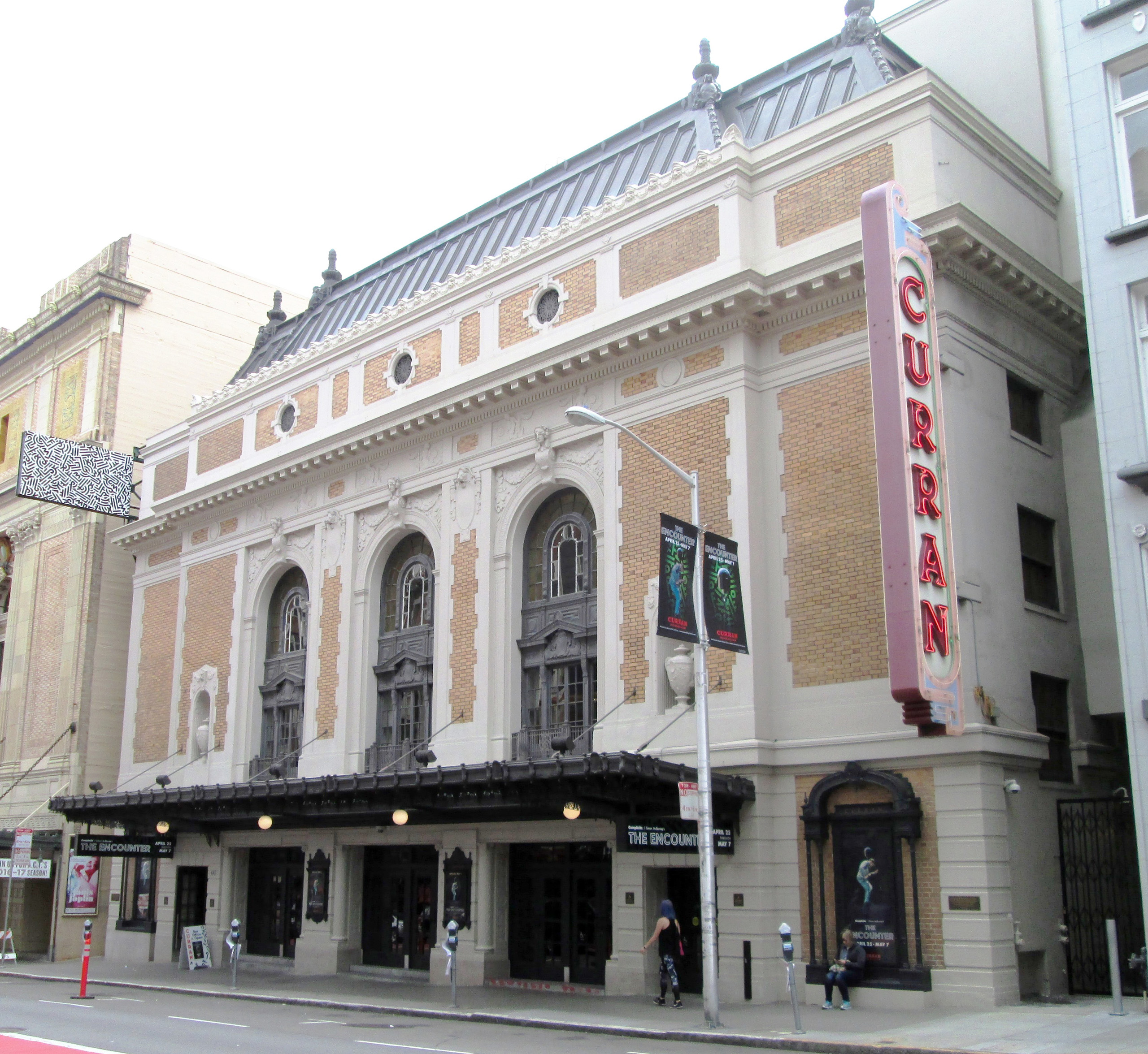 Historic Curran Theatre exterior with marquee and vertical sign.