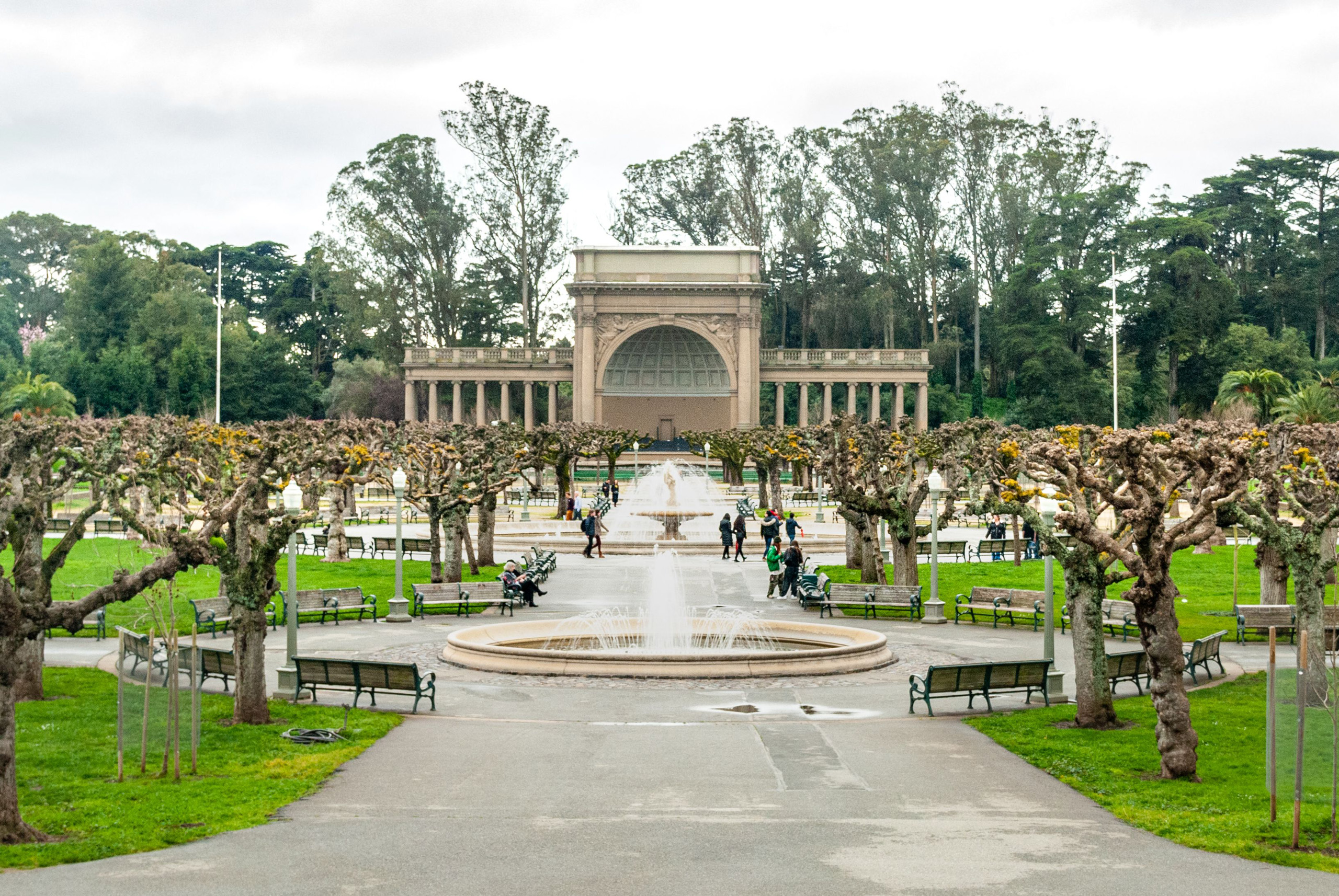 Fountain and bandshell surrounded by trees and benches.