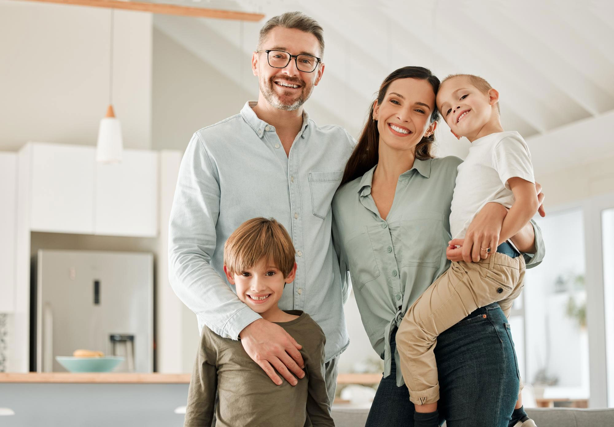 Family standing together in the kitchen of a bright, comfortable home