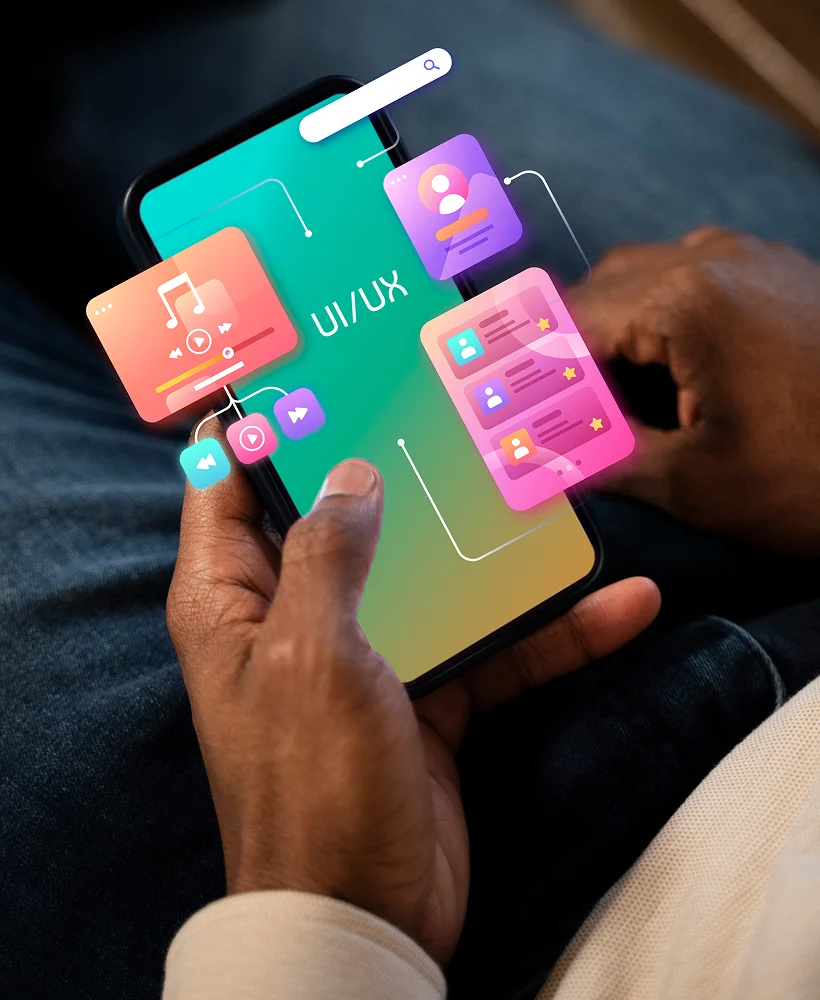 Person holding smartphone displaying UI/UX design with music and profile app interface icons.