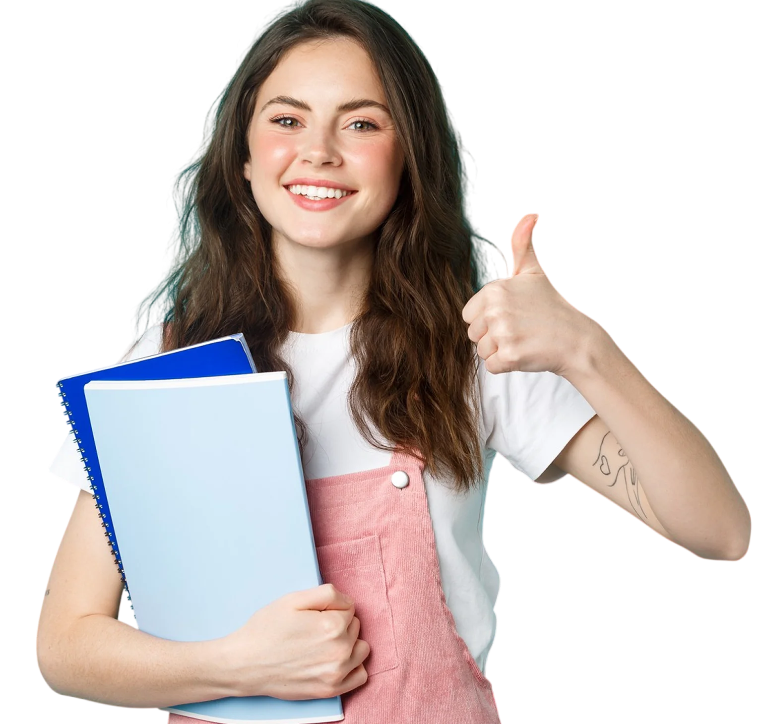 Smiling young woman with long brown hair wearing a white t-shirt and pink overalls holding two notebooks and giving a thumbs up.