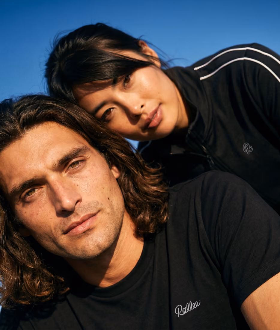 AI generated custom casting example, a man and woman in black Rallee sportswear against a deep blue sky
