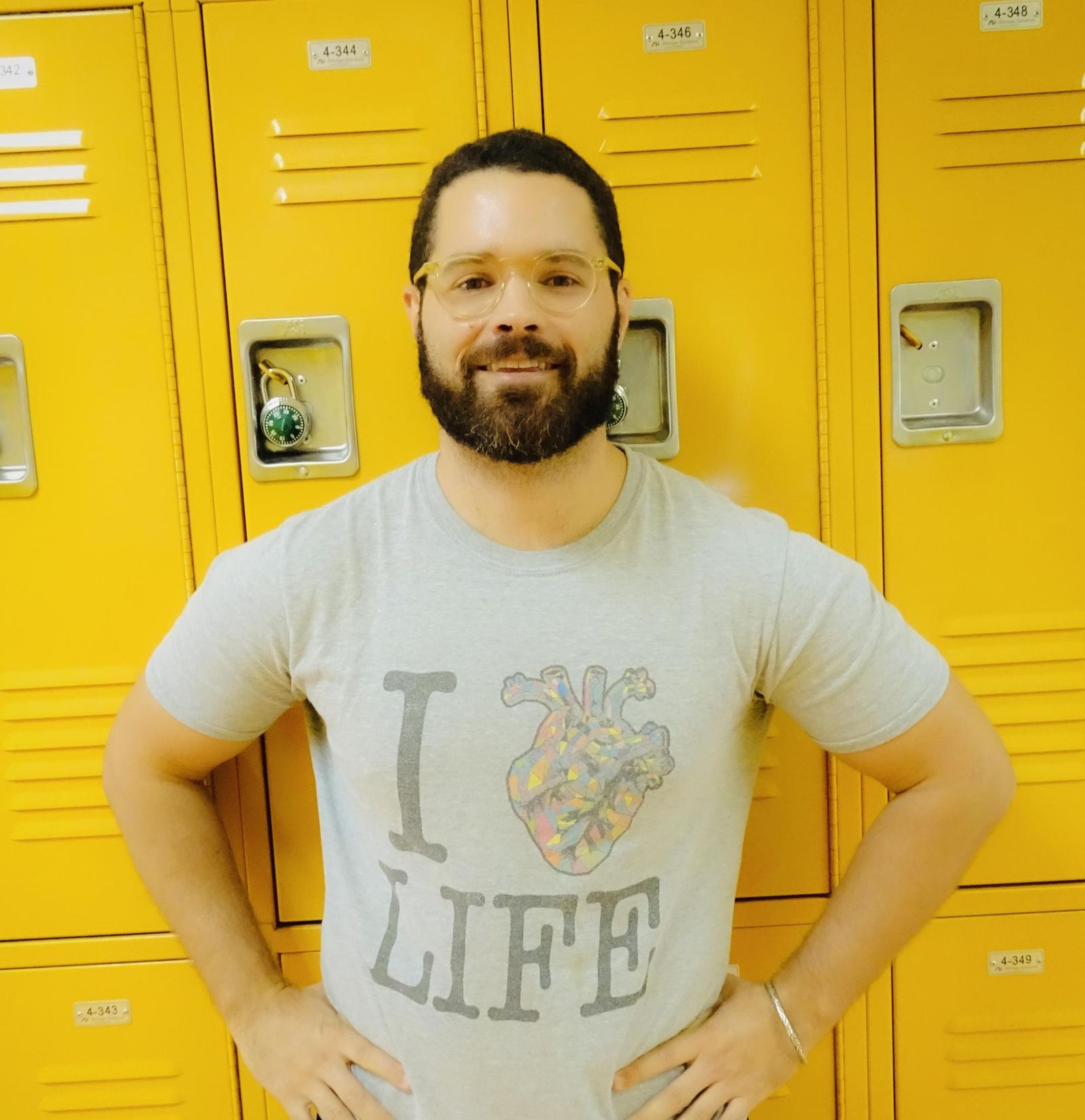 Cody Gordon standing confidently by yellow hallway lockers
